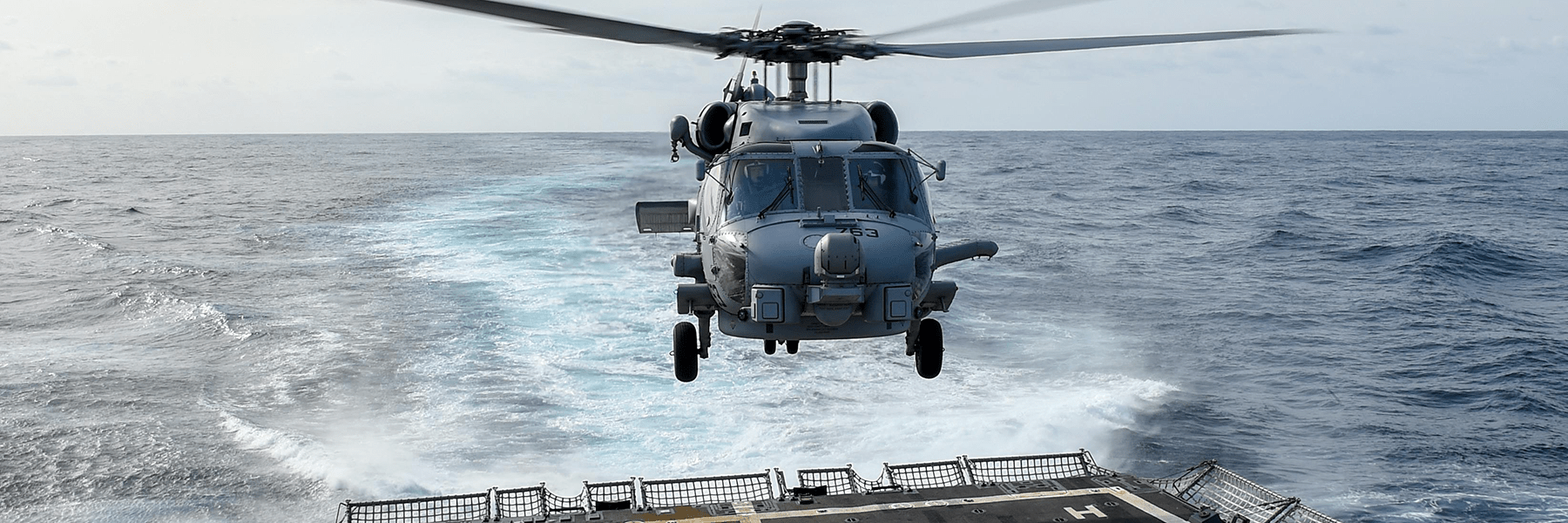 Helicopter landing on a ship at sea